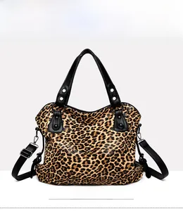 Front view of leopard print tote bag featuring black handles and detachable shoulder strap