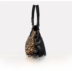 Detail view of the leopard print and black leather splicing on the tote bag side