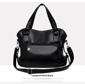 Detail of black pebbled leather tote bag with leopard print side panels and back zip pocket