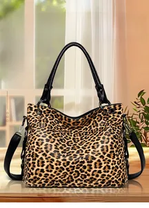 Detail of elegant leopard print tote bag with leather handles and metal ring hardware