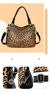 Detail of leopard print tote bag with pebbled texture and gunmetal hardware accents