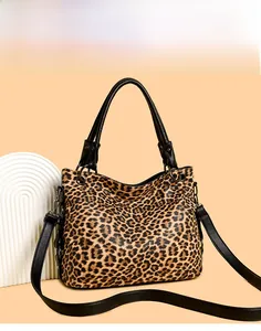 Close-up of leopard print tote bag with black handles and metal ring hardware