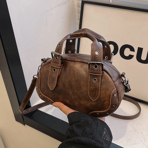 Vintage dark brown bowling bag with rivet details and distressed leather texture