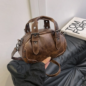 Vintage dark brown bowling bag with silver rivets and distressed leather texture