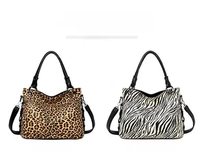 Detail view of leopard and zebra print tote bags with adjustable black leather straps