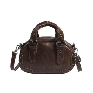 Vintage dark brown bowling bag with cracked leather texture and metal rivet accents