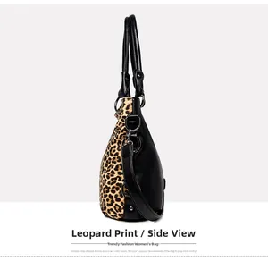 Detail of leopard print tote side showing lychee grain leather and metal rings