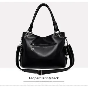 Detailed back view of black lychee grain leather tote bag with adjustable strap