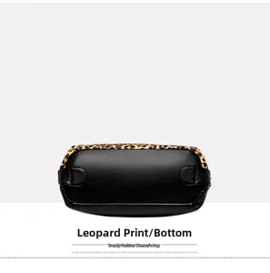 Detailed bottom view of large tote bag featuring black pebbled leather and leopard print edges