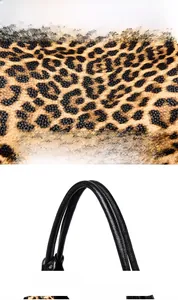 Detail of leopard print fabric and black lychee grain leather handle with precise stitching