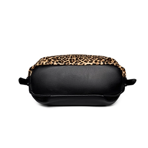 Large capacity leopard print tote bag with black pebbled leather bottom in a 45-degree view