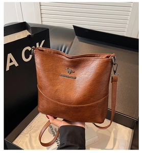 Brown vintage bucket bag detail with kangaroo logo next to premium gift box packaging
