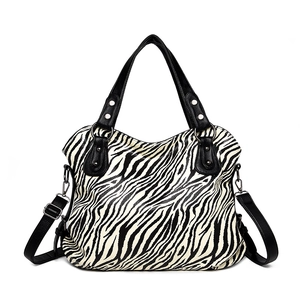 Large capacity zebra print tote bag with black faux leather handles and silver hardware
