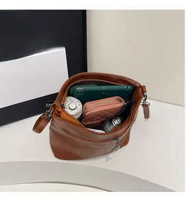 Interior view of brown bucket bag showing large capacity for tablet, wallet, and umbrella