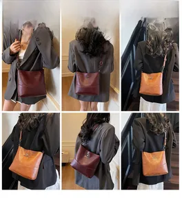 Detailed model views of wine red and tan crossbody bucket bags with kangaroo logo