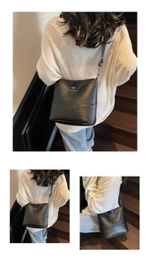 Detail of black pebbled leather bucket bag with silver kangaroo logo and adjustable strap