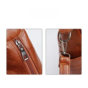 Detail of brown lychee grain leather handbag featuring silver metal zipper and D-ring buckle
