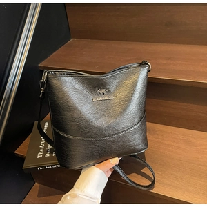 Detail of lychee pattern PU leather on black bucket bag with gold kangaroo logo