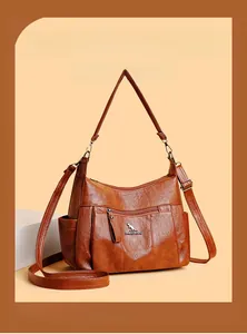 Detailed view of brown retro textured shoulder bag with zipper and kangaroo logo