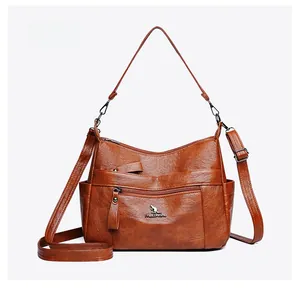 Detailed side view of brown PU leather handbag with multi-pocket design and zip closure