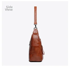 Side view of brown retro shoulder bag showing faux leather texture and zipper detail