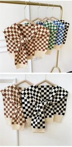Detail view of knitted checkered shawls in brown, green, blue, and black color options