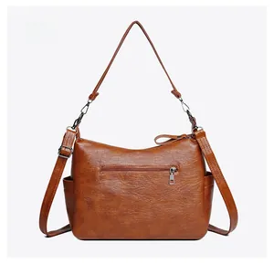 Detailed back view of brown PU leather shoulder bag featuring zipper pocket and side slots