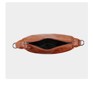 Detailed top view of brown pleated PU leather crossbody bag with metal zipper and lining