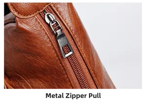 Close-up of gunmetal zipper pull on brown lychee grain leather handbag detail