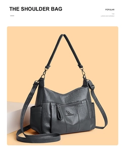Detail showing charcoal grey textured leather bag with kangaroo logo and side pockets