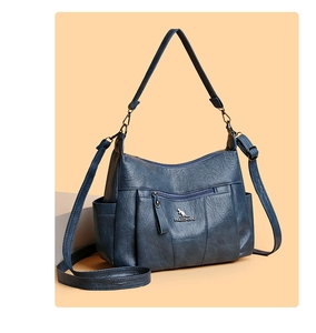 Detail of blue-grey litchi leather tote bag with front zipper pocket and kangaroo logo
