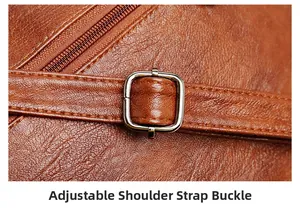 Detail of adjustable metal buckle and lychee grain leather on brown shoulder bag
