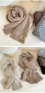 Close-up of thick knit winter scarf texture with premium branded leather tag detail