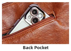 Detail view of brown lychee grain leather crossbody bag showing functional back zip pocket