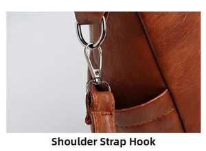 Detail of the caramel leather shoulder bag showing the metal strap hook and fine texture