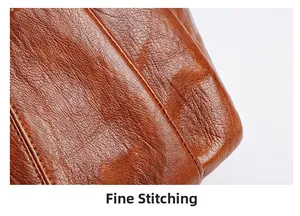 Detail shot of the fine stitching and natural texture on the brown leather shoulder bag