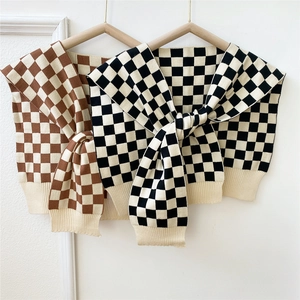 Two-tone checkered knitted shawl wrap with tie knot and ribbed hem in brown and black