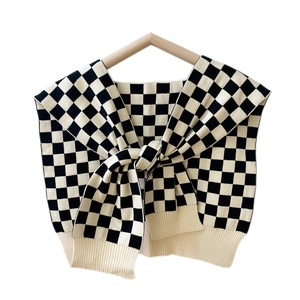 Classic black and white checkerboard knit shawl wrap with ribbed edges and knotted front style