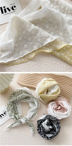 Detailed embroidery texture of cotton linen triangle scarf with floral patterns