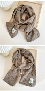 Detailed knit texture and brand label of a khaki chunky knit long scarf shawl