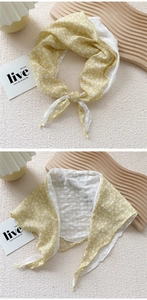 Close-up of floral cotton headscarf with white lace embroidery and scalloped edges