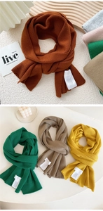 Close-up of soft knit long scarf texture in caramel and earthy tones for autumn