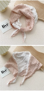 Detail of pink floral cotton scarf and white lace hollow pattern with neat edges