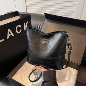 Elegant black pebble leather bucket bag with metallic kangaroo logo and adjustable strap
