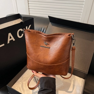 Chic brown litchi pattern leather shoulder bag with adjustable strap and silver logo