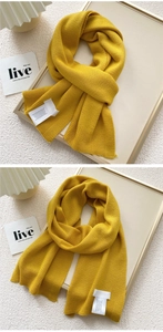 Detail of ginger yellow knitted scarf showing fine stitching and soft ribbed edge texture