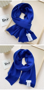 Close-up of Klein blue knit scarf texture and soft fabric on decorative background