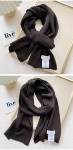 Detailed view of dark coffee rib-knitted scarf texture and soft fabric wash label