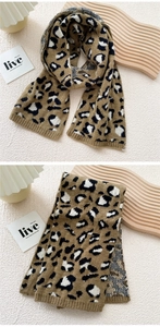 Close-up of thick leopard print knit scarf in warm brown and black tones for winter