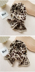 Macro detail of leopard print knit scarf showing fine ribbed texture and soft wool material